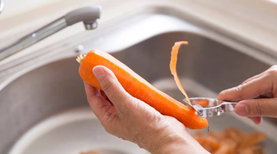 Image of a person peeling a carrot